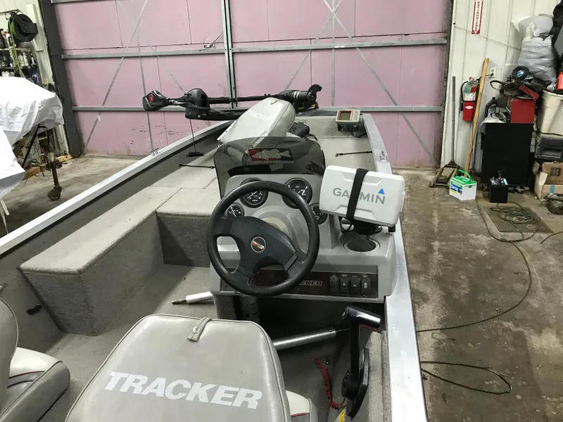 Slide: The Image of 1997 Bass Tracker Pro Team 175 boat interior with Garmin GPS in a garage setting. - 6