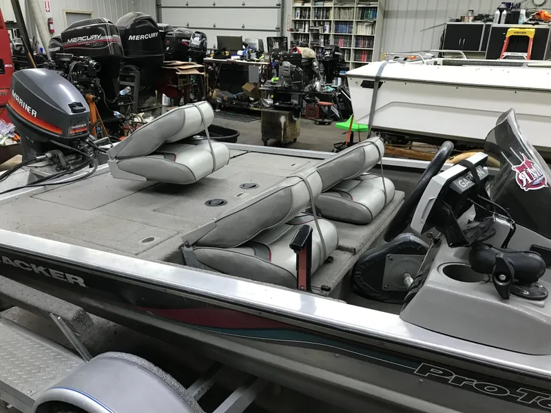 Slide: The Image of 1997 Bass Tracker Pro Team 175 boat in a workshop with Mercury outboard motor. - 7