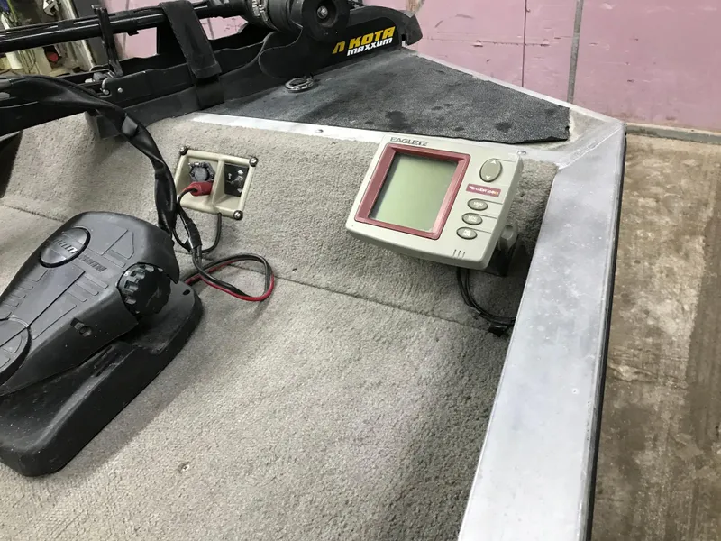 Slide: The Image of 1997 Bass Tracker Pro Team 175 boat dashboard with fish finder and controls. - 8