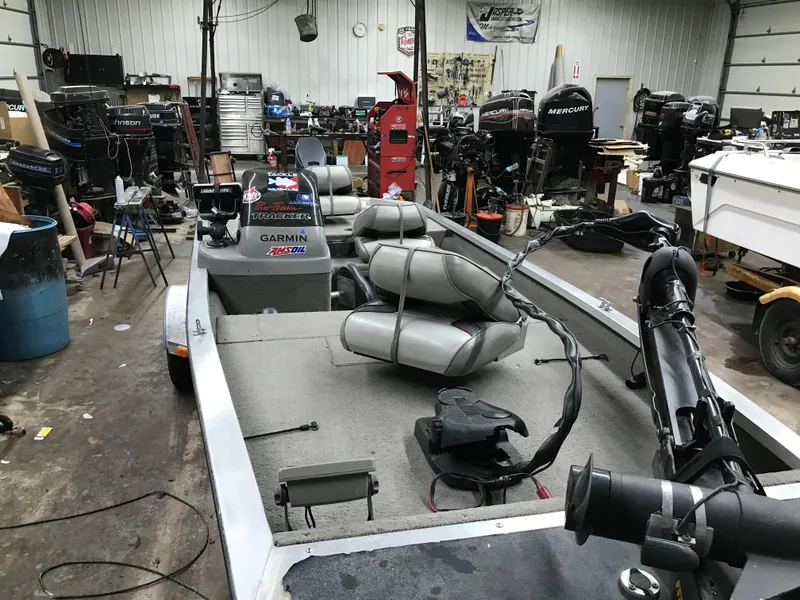 Slide: The Image of 1997 Bass Tracker Pro Team 175 boat in a workshop with equipment and tools. - 9