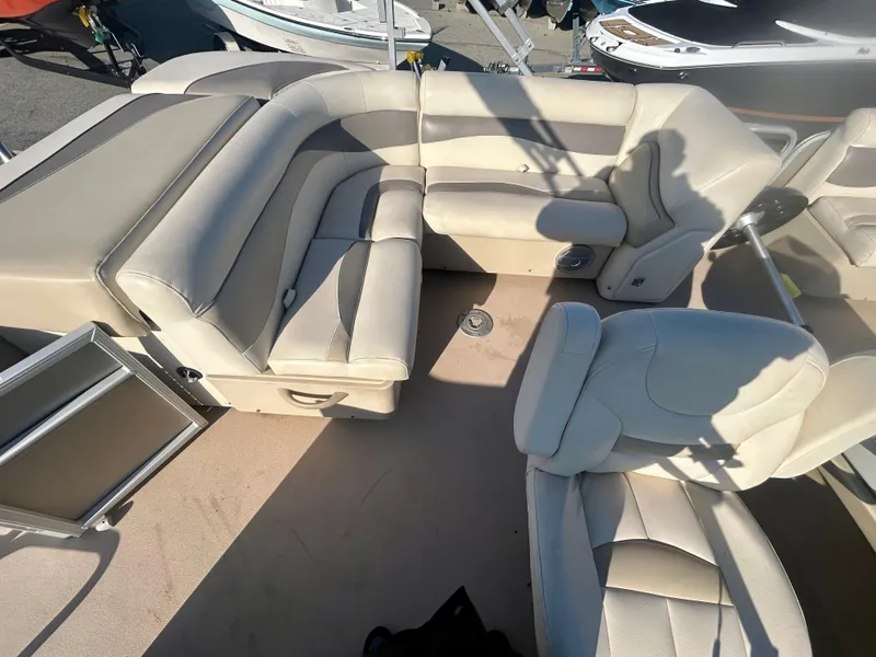 Slide: The Image of 2016 Godfrey SWEETWATER 200 boat interior with beige seating and spacious layout. - 10