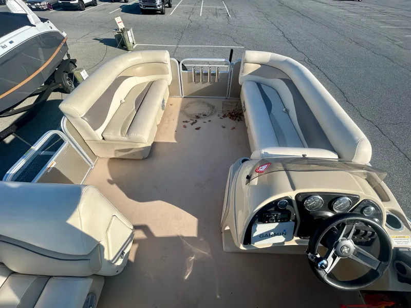 Slide: The Image of 2016 Godfrey SWEETWATER 200 pontoon boat interior with beige seating and steering console. - 12