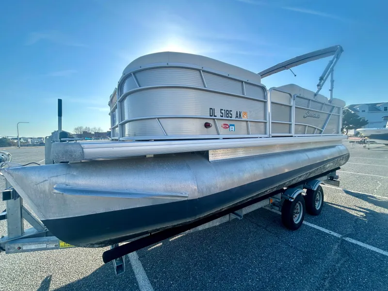 Slide: The Image of 2016 Godfrey SWEETWATER 200 pontoon boat on trailer in parking lot. - 2