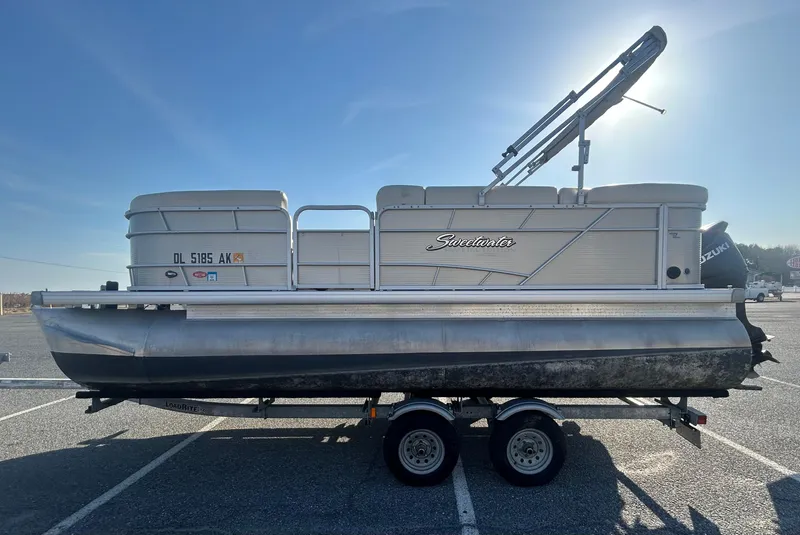 Slide: The Image of 2016 Godfrey SWEETWATER 200 pontoon boat on trailer in parking lot. - 3