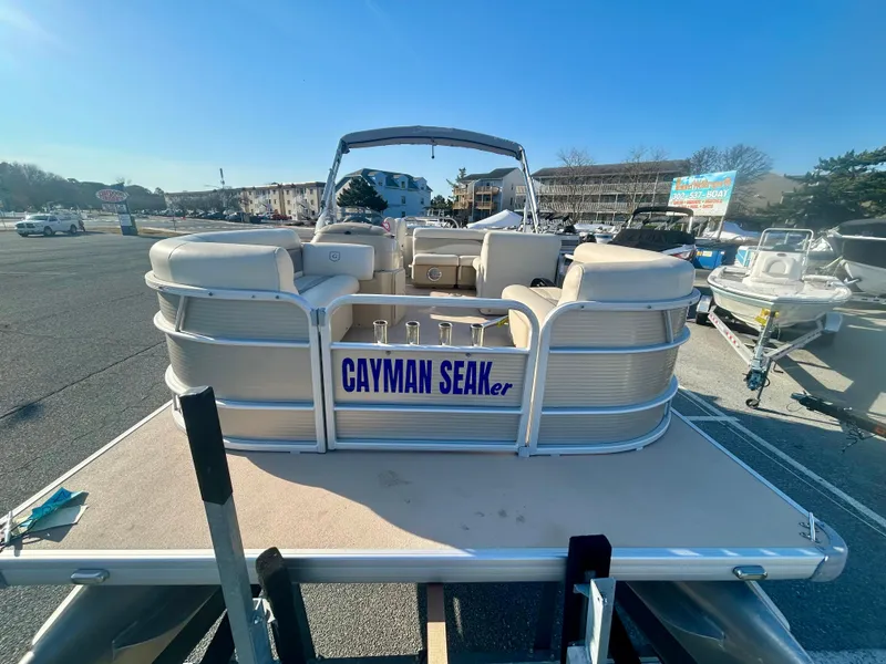 Slide: The Image of 2016 Godfrey SWEETWATER 200 pontoon boat on trailer, labeled "CAYMAN SEAKER," in a parking lot. - 4