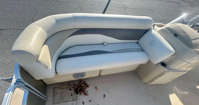 Slide: The Image of 2016 Godfrey SWEETWATER 200 boat seating with beige upholstery and storage compartment. - 6