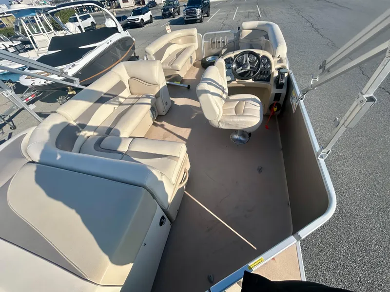 Slide: The Image of 2016 Godfrey SWEETWATER 200 pontoon boat interior with beige seating and steering console. - 9