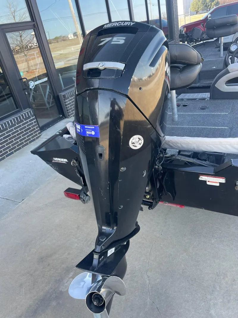 Slide: The Image of 2020 Tracker PT175 boat with Mercury 75 outboard motor, parked outside a building. - 6