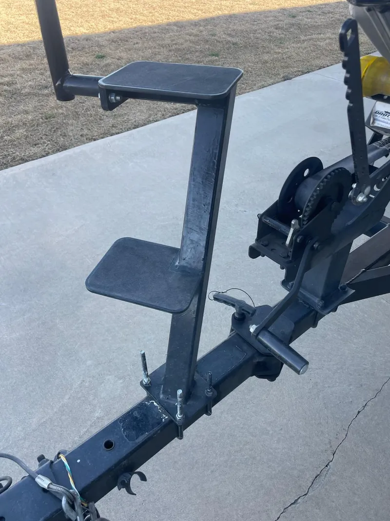 Slide: The Image of 2020 Tracker PT175 trailer step ladder on concrete surface. - 8