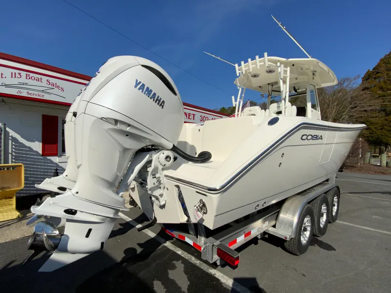 Slide: The Image of 2025 Cobia 320 Center Console boat with Yamaha engine on a trailer. - 10