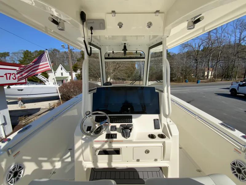 Slide: The Image of 2025 Cobia 320 Center Console boat interior with modern dashboard and steering wheel. - 13