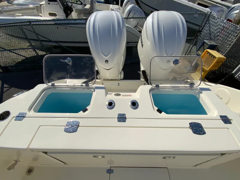 Slide: The Image of 2025 Cobia 320 Center Console with dual engines and open storage compartments. - 19