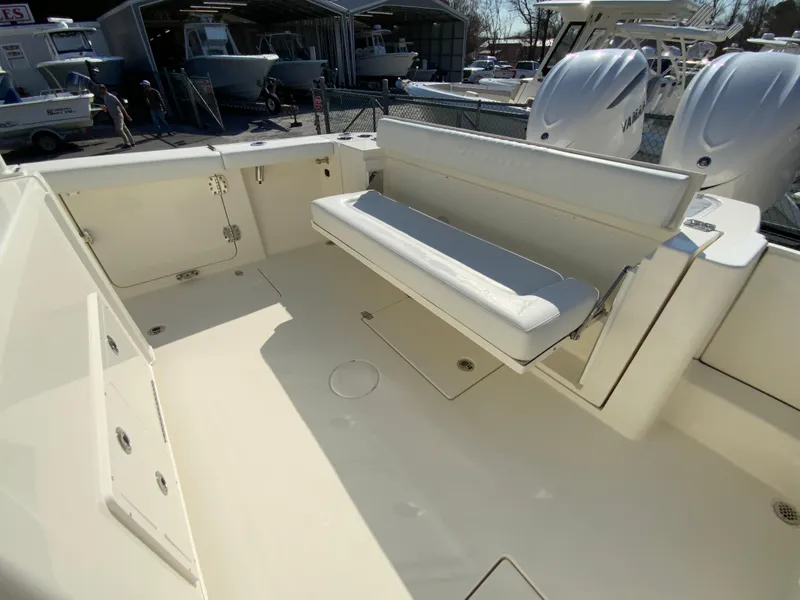 Slide: The Image of 2025 Cobia 320 Center Console boat interior with seating and storage compartments. - 20