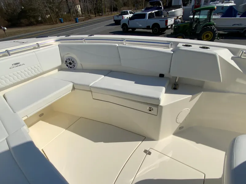 Slide: The Image of 2025 Cobia 320 Center Console boat interior with white seating and speaker. - 25