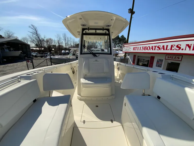 Slide: The Image of 2025 Cobia 320 Center Console boat at dealership, showcasing spacious seating and helm. - 30