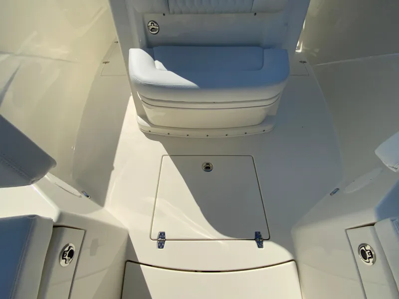 Slide: The Image of 2025 Cobia 320 Center Console boat interior with seating and storage compartments. - 31
