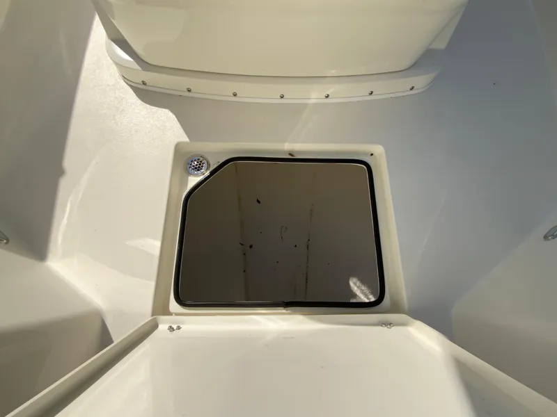 Slide: The Image of 2025 Cobia 320 Center Console boat storage compartment, open hatch view. - 32