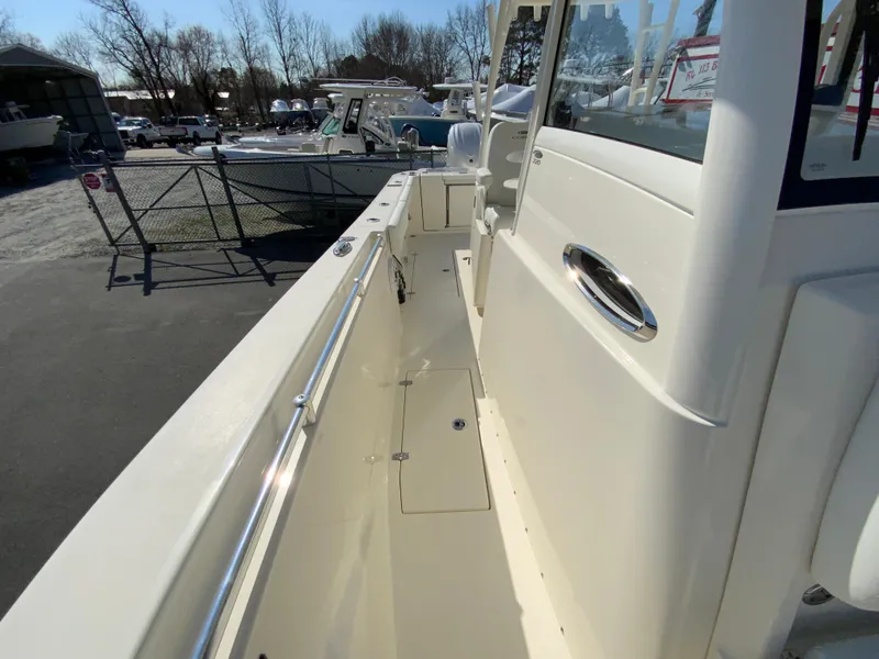 Slide: The Image of 2025 Cobia 320 Center Console boat, side view, docked outdoors. - 38