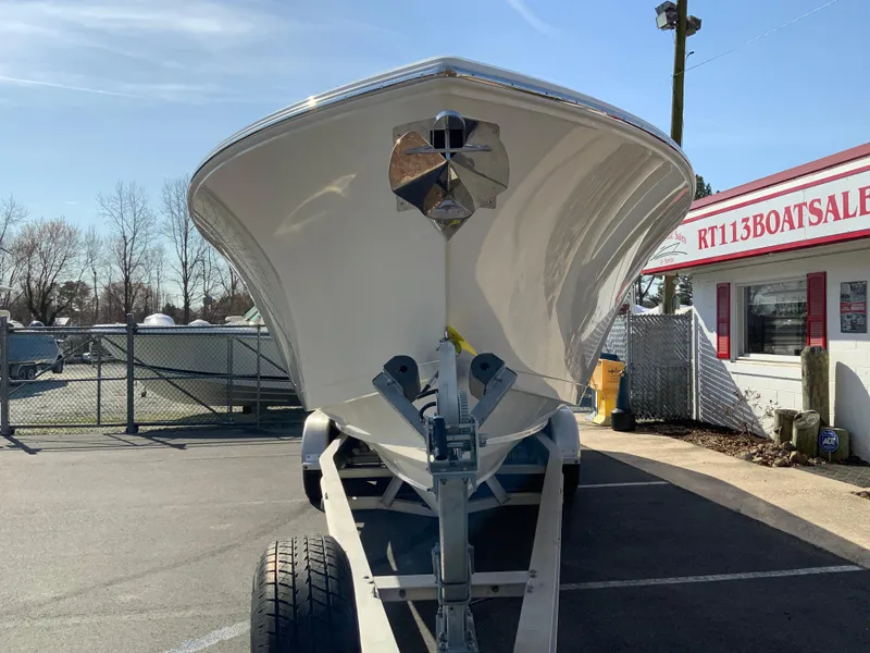 Slide: The Image of 2025 Cobia 320 Center Console boat on trailer at dealership. - 4