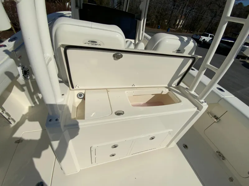 Slide: The Image of 2025 Cobia 320 Center Console boat interior with open storage compartment. - 41