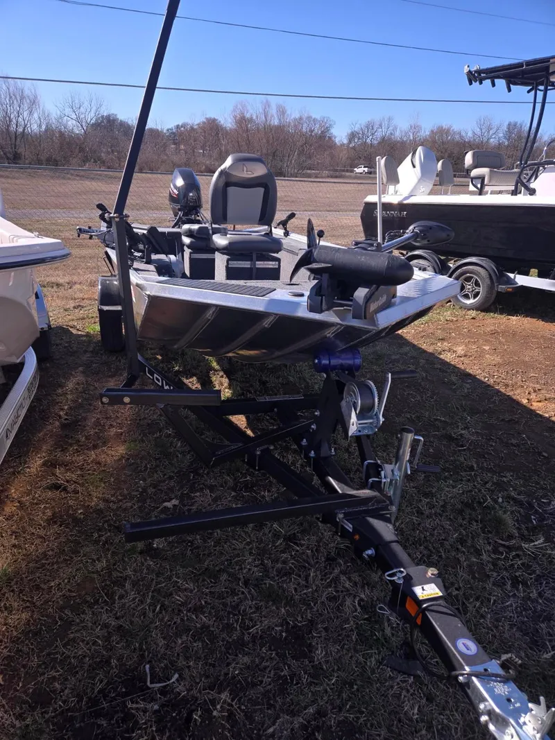 Slide: The Image of 2023 Lowe Skorpion 16 fishing boat on trailer, parked outdoors. - 0