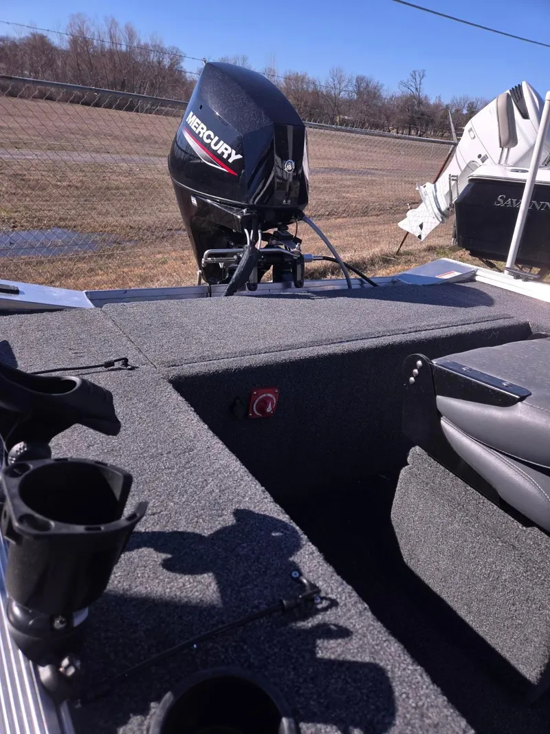 Slide: The Image of 2023 Lowe Skorpion 16 boat with Mercury outboard motor, parked outdoors. - 4