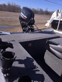 Slide: The Image of 2023 Lowe Skorpion 16 boat with Mercury engine, outdoor setting, gray interior. - 9