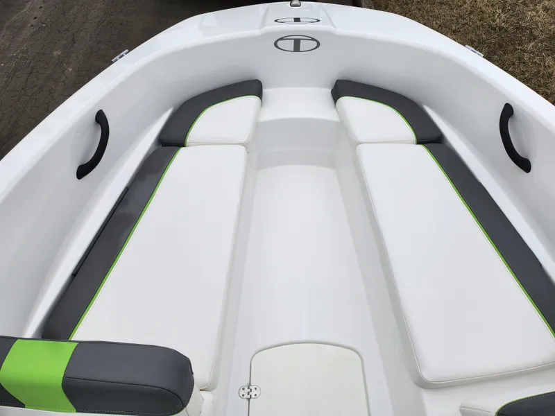Slide: The Image of 2023 Tahoe T16 boat interior with white and green cushioned seating. - 16
