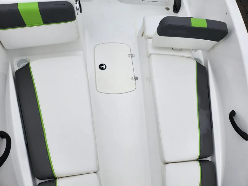 Slide: The Image of 2023 Tahoe T16 boat interior with white and green cushioned seats. - 17