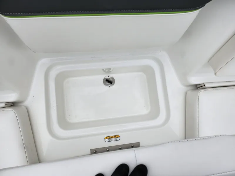 Slide: The Image of 2023 Tahoe T16 boat interior with white seating and storage compartment. - 20