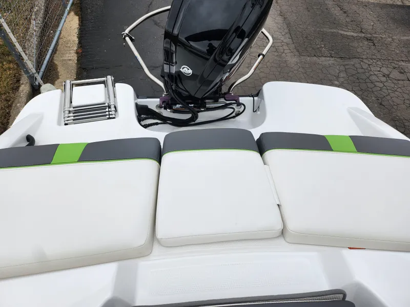 Slide: The Image of 2023 Tahoe T16 boat with white and green seating, outboard motor, and sleek design. - 21