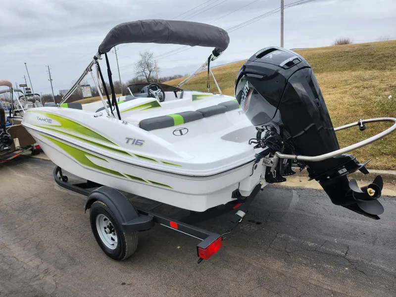 Slide: The Image of 2023 Tahoe T16 boat on trailer with outboard motor, parked on a road. - 3