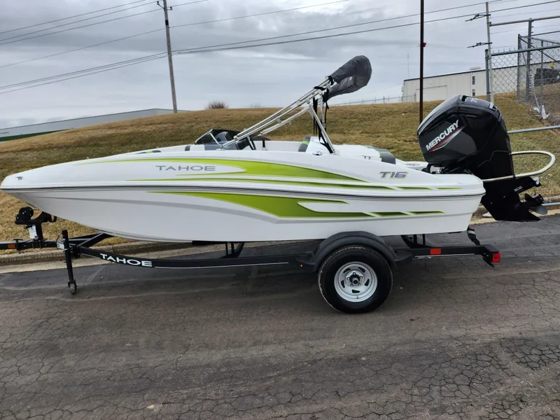 Slide: The Image of 2023 Tahoe T16 boat on trailer with green accents and Mercury outboard motor. - 4