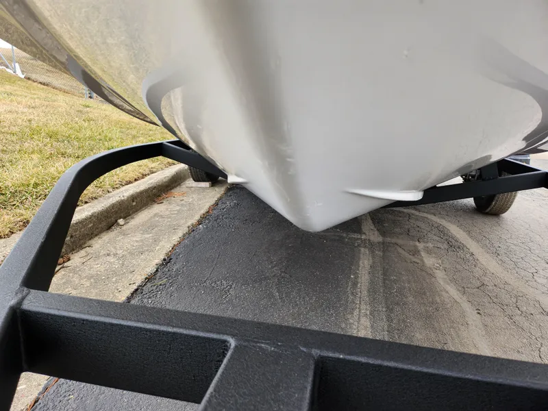 Slide: The Image of 2023 Tahoe T16 boat on trailer, close-up view of hull and frame. - 7