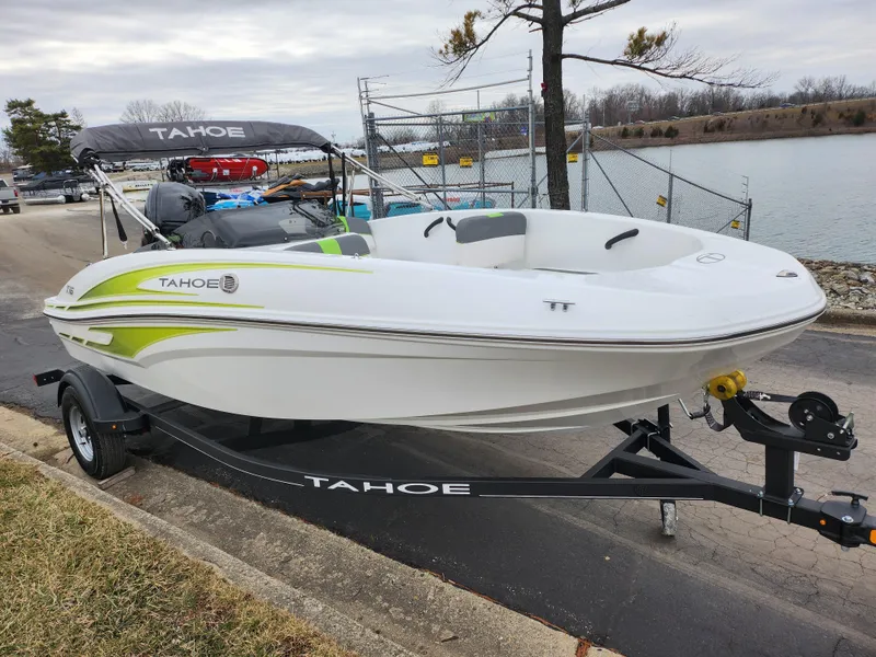 Slide: The Image of 2023 Tahoe T16 boat on trailer by lakeside, featuring sleek design and vibrant accents. - 8