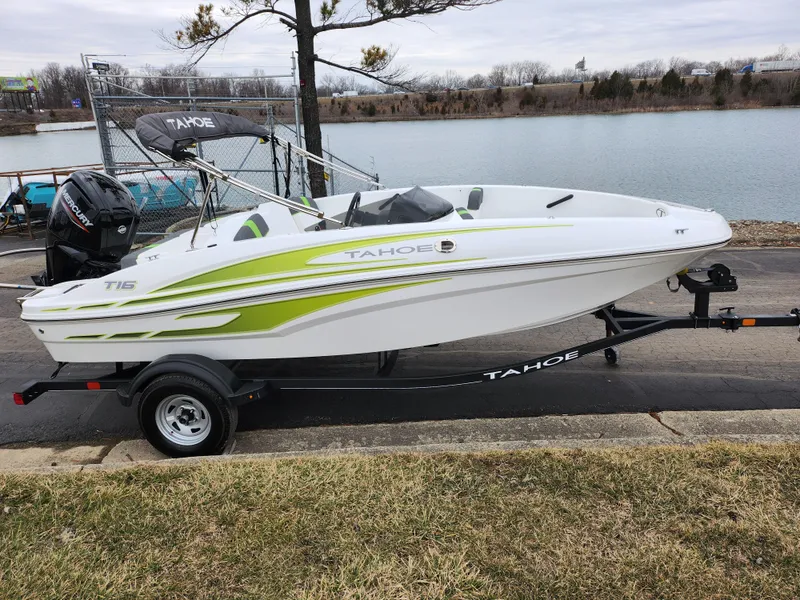 Slide: The Image of 2023 Tahoe T16 boat on trailer by a lakeside. - 9