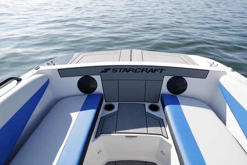 Slide: The Image of 2025 Starcraft SV 16 OB boat interior with blue and gray seating on calm water. - 10