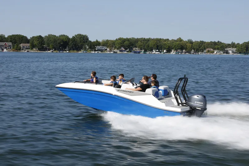 Slide: The Image of 2025 Starcraft SV 16 OB boat speeding on a lake with passengers. - 25