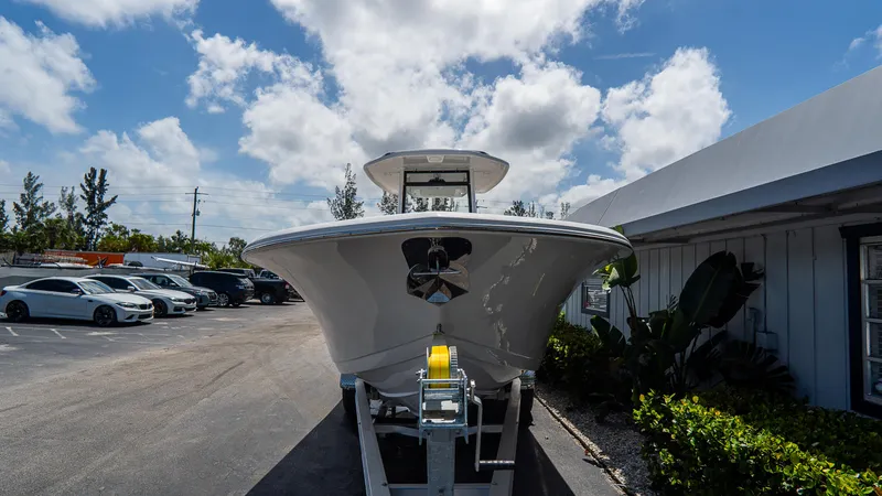 Slide: The Image of 2025 Tidewater 256 LXF boat on trailer under a partly cloudy sky. - 3