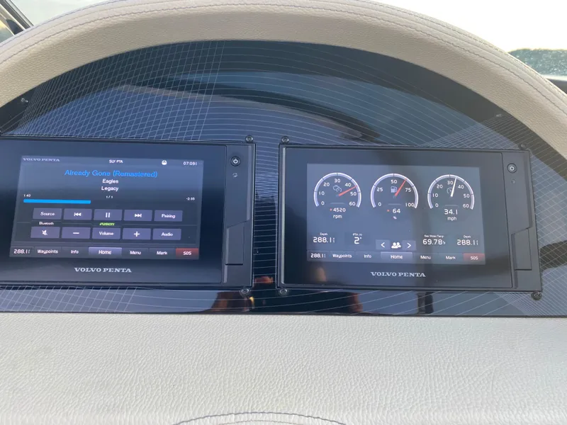 Slide: The Image of Dashboard of 2021 Regal 2800 Bowrider with Volvo Penta displays showing music and engine data. - 15