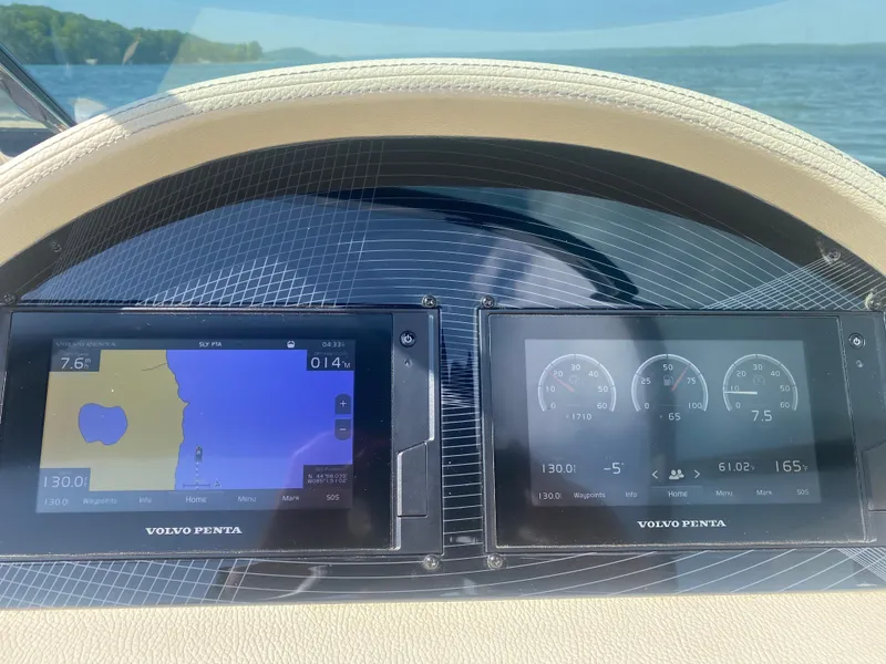 Slide: The Image of Dashboard of 2021 Regal 2800 Bowrider with Volvo Penta displays on a sunny day. - 16