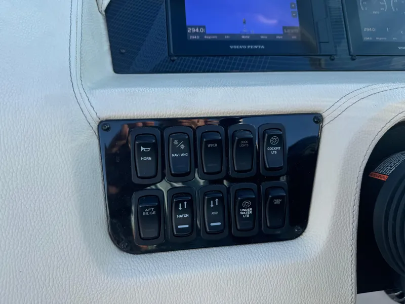 Slide: The Image of Dashboard controls of a 2021 Regal 2800 Bowrider boat, featuring various switches and a display. - 17
