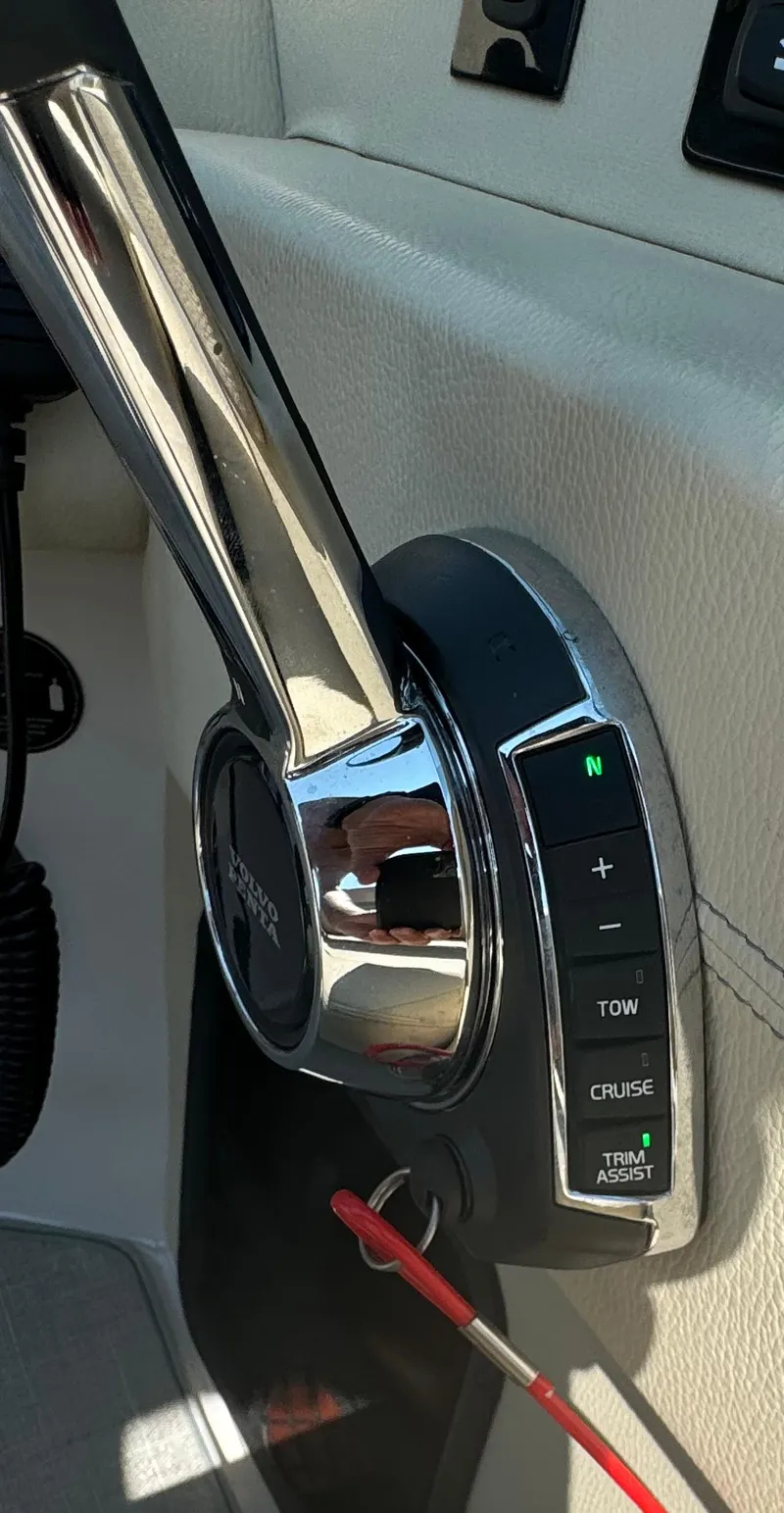 Slide: The Image of Close-up of 2021 Regal 2800 Bowrider throttle control with cruise and trim assist features. - 19