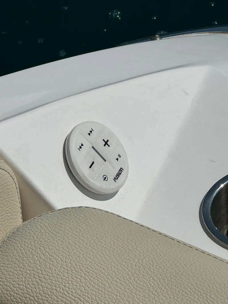 Slide: The Image of Fusion audio control on 2021 Regal 2800 Bowrider boat, beige upholstery. - 25