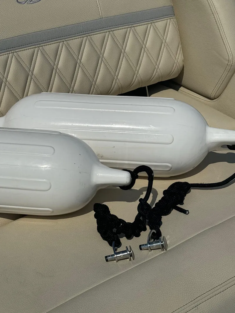 Slide: The Image of White boat fenders on Regal 2800 Bowrider 2021 seat with black ropes. - 26