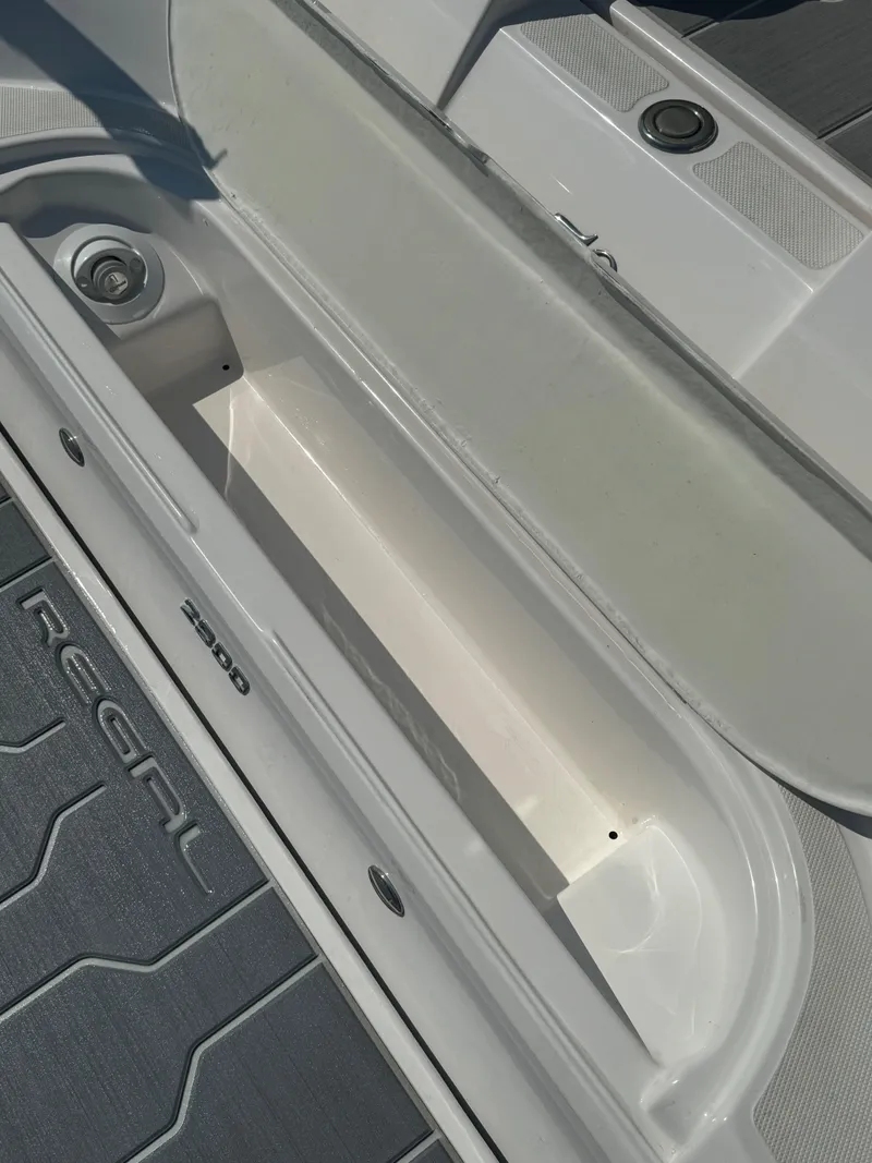 Slide: The Image of 2021 Regal 2800 Bowrider storage compartment with sleek design and durable flooring. - 27