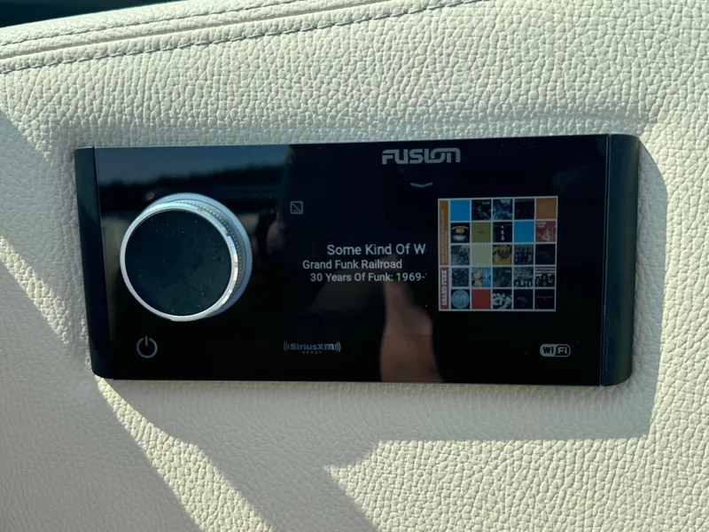 Slide: The Image of Fusion stereo system on 2021 Regal 2800 Bowrider, displaying music track details. - 30