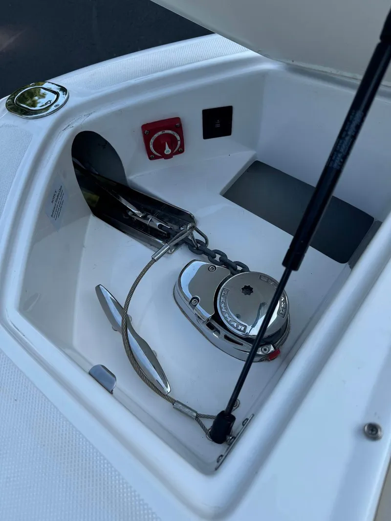 Slide: The Image of Anchor compartment of 2021 Regal 2800 Bowrider boat with winch and controls. - 31