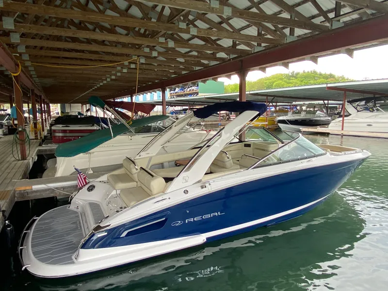 Slide: The Image of 2021 Regal 2800 Bowrider docked in a marina under a covered structure. - 36