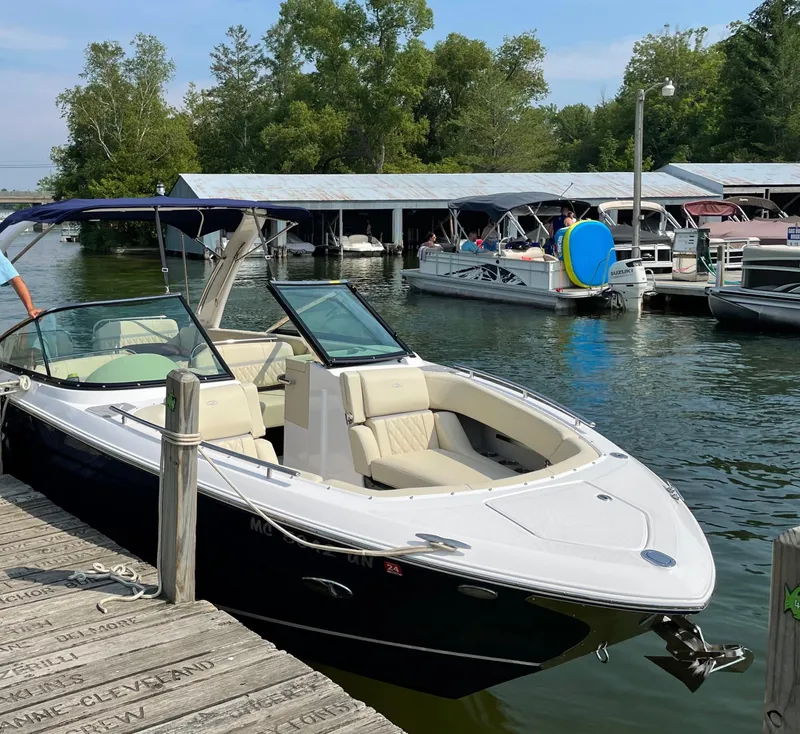 Slide: The Image of 2021 Regal 2800 Bowrider docked at a marina with other boats nearby. - 4